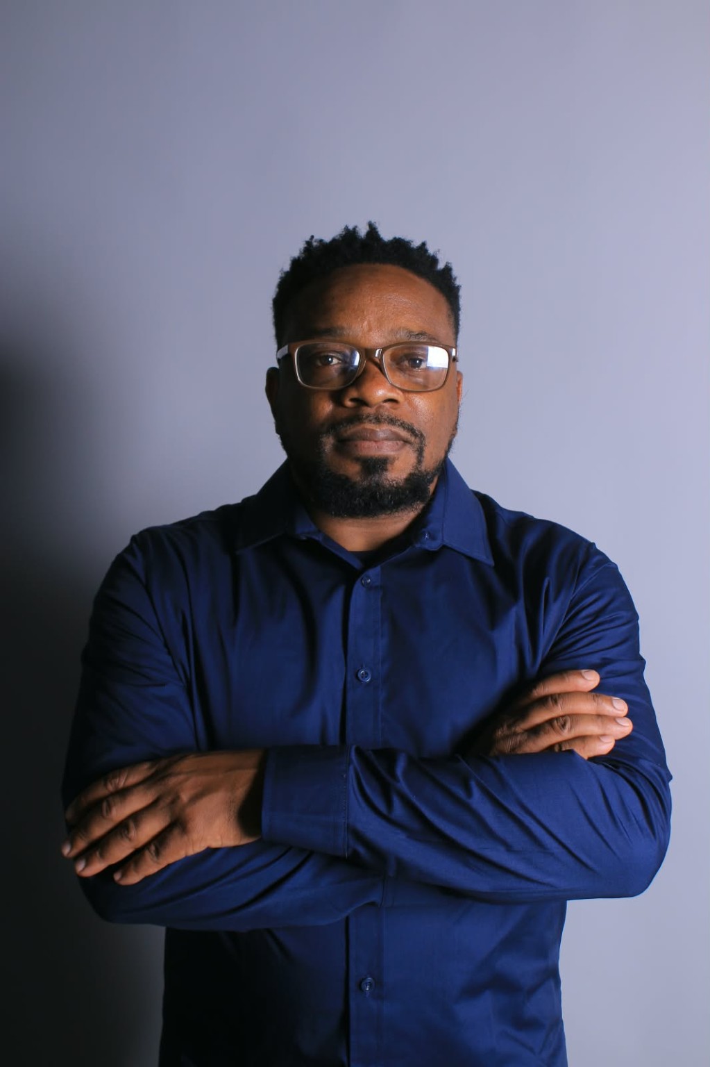 Dr. Arthur Mangwende, photographed with arms folded